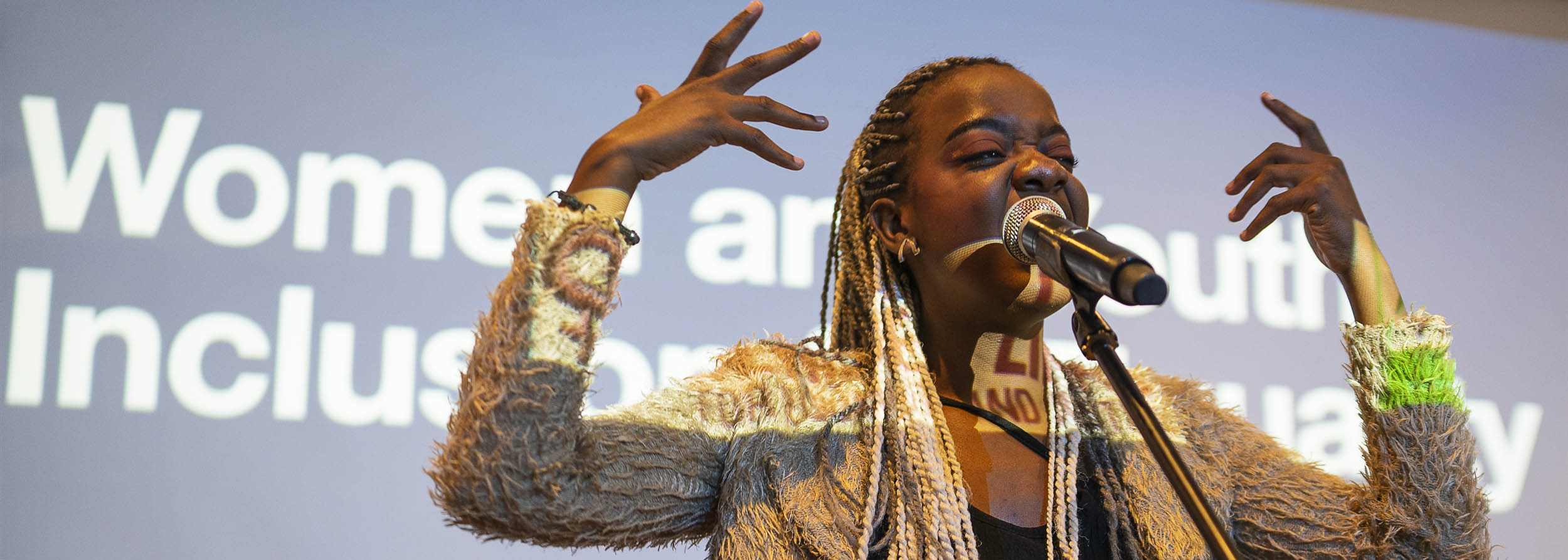 An empowering women giving a speech during an event.